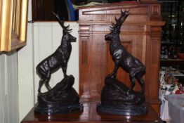 Pair of large bronze stags each on rocky outcrop mounted on marble bases, 76cm.