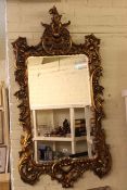 Ornate crested gilt framed rectangular bevelled wall mirror, 152 x 78cm overall.