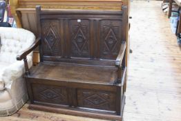 Carved oak triple panel back box settle, 110 x 102cm.