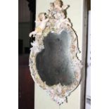 Large Continental cherub and floral decorated porcelain framed mirror, 85 x 48cm.