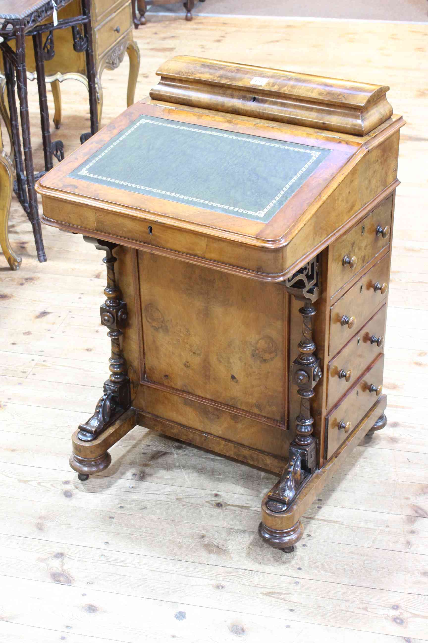 Victorian figured walnut davenport fitted with stationery compartments and four side drawers,