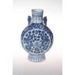 Chinese blue and white moon flask vase with floral and dragon design, 25.5cm.