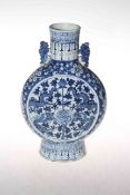 Chinese blue and white moon flask vase with floral and dragon design, 25.5cm.