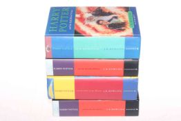 Four Harry Potter First Edition books.