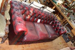 Ox blood buttoned leather three seater Chesterfield settee.