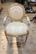 Gilt painted oval panel back fauteuil.
