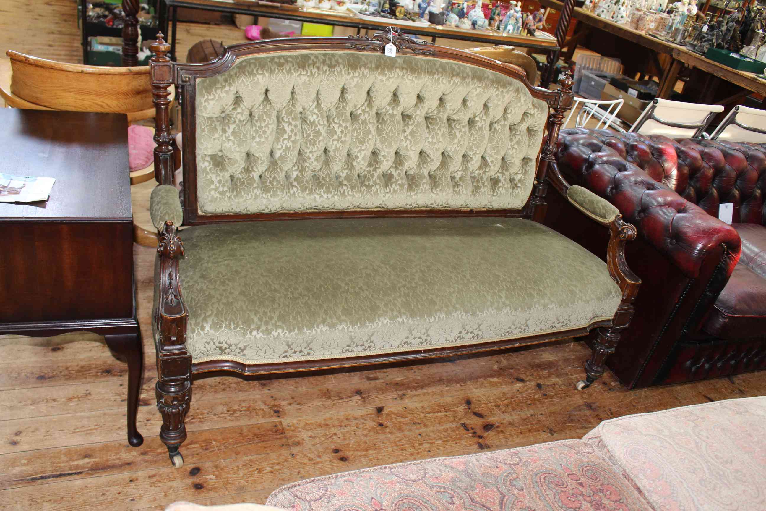 Victorian carved mahogany framed parlour settee in green buttoned fabric.