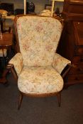 Ercol armchair in buttoned tapestry fabric.