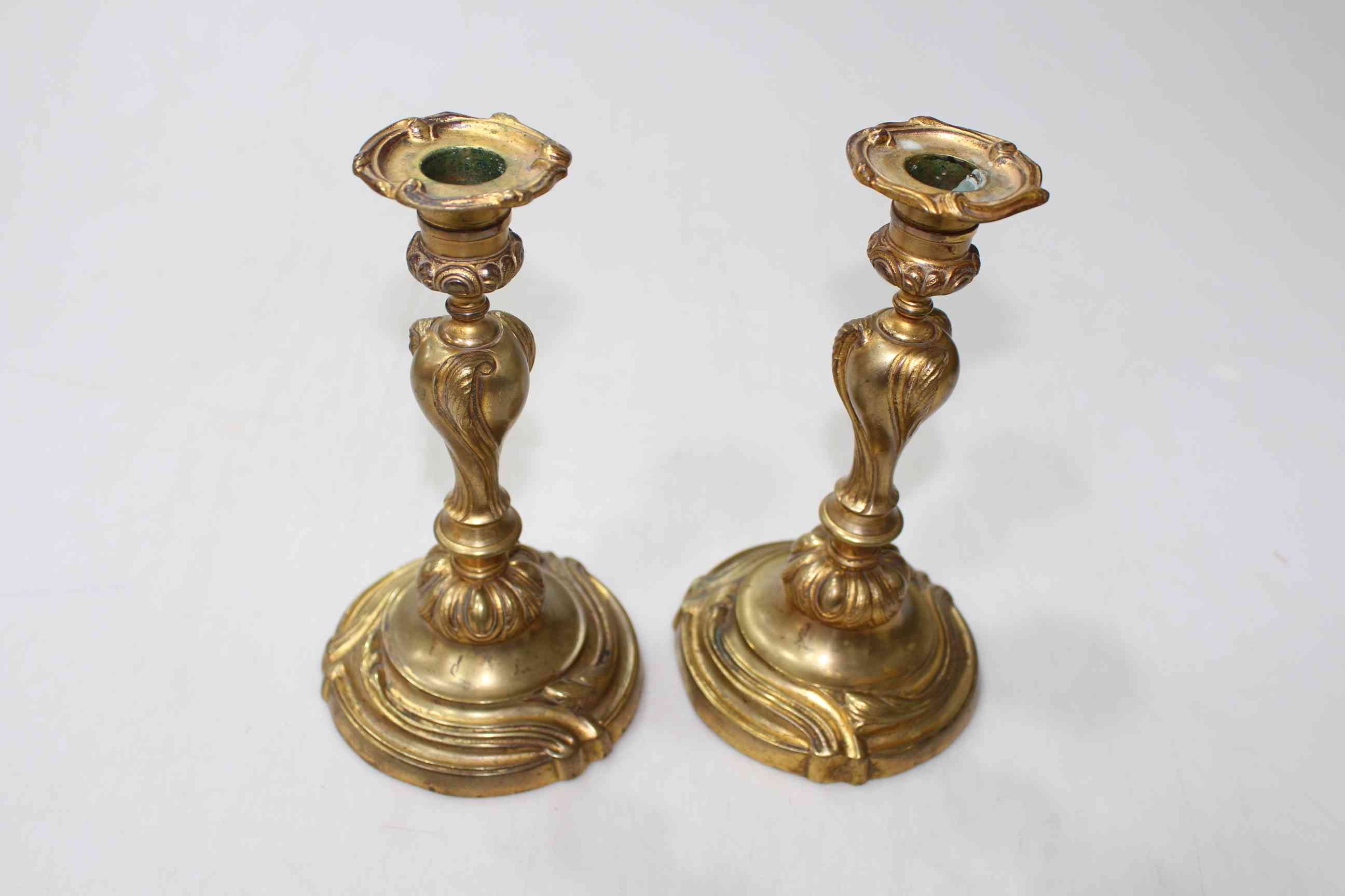 Pair 19th Century gilt bronze Rococo style candlesticks, 21cm.