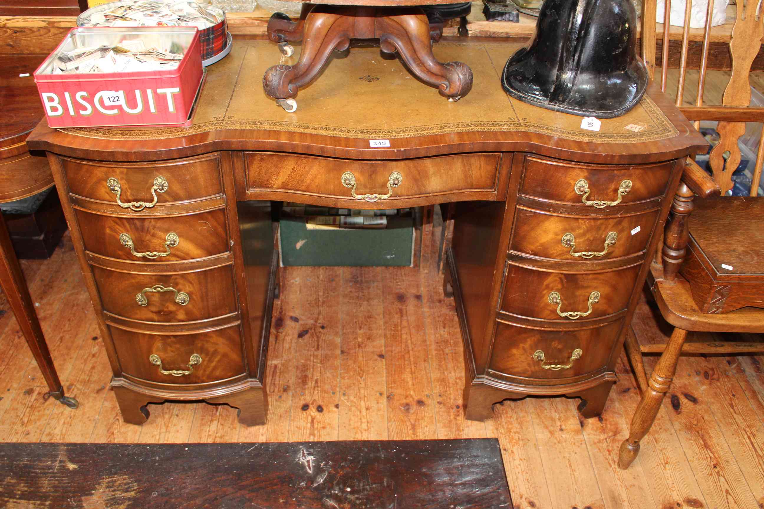 Bevan Funnell Reprodux nine drawer serpentine front pedestal desk, 75cm by 115cm by 53.5cm.