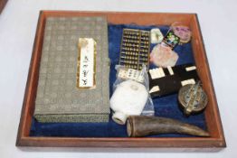 Small table display with Chinese and other artifacts.