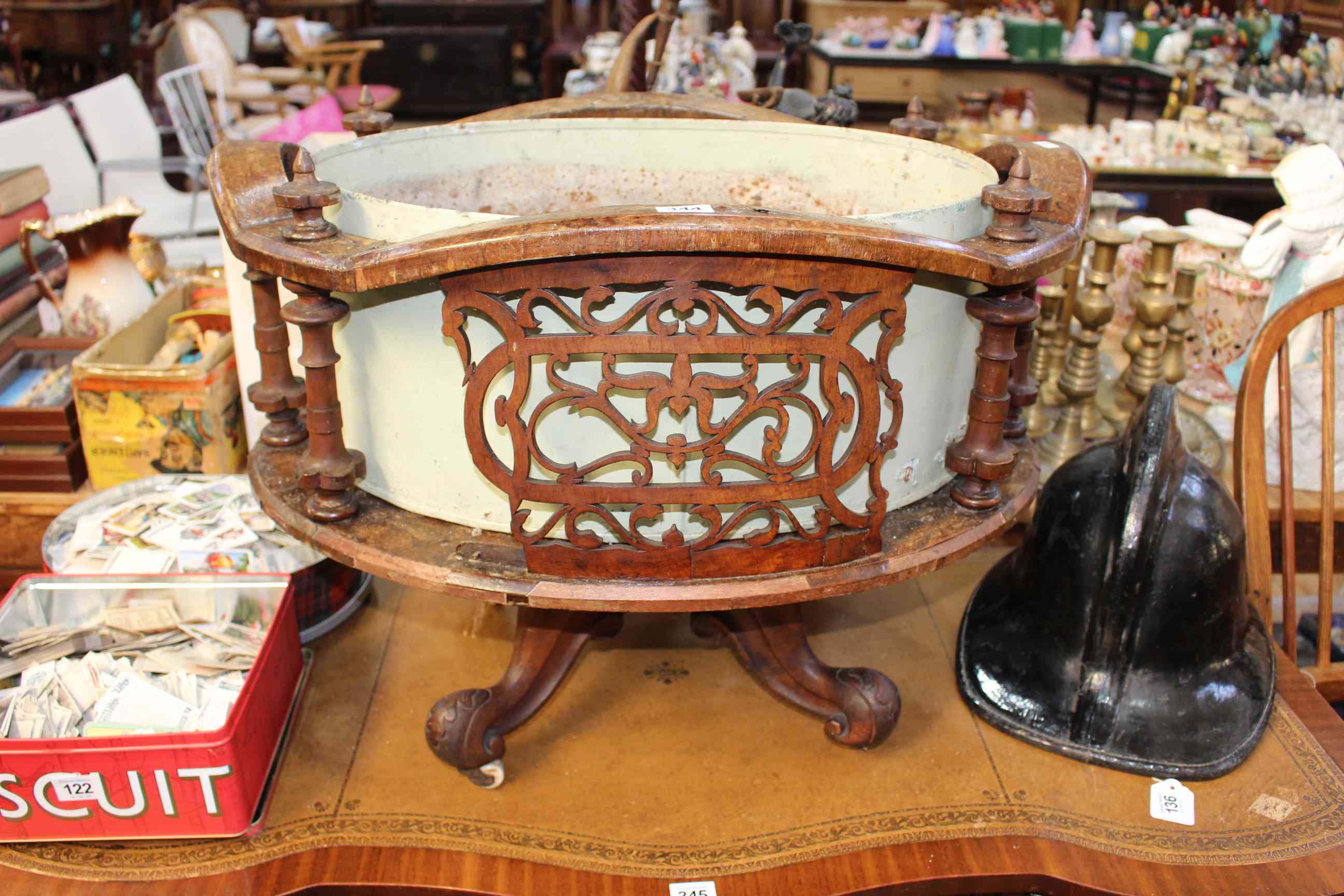 Victorian walnut oval fretwork panelled planter on four scrolled legs.