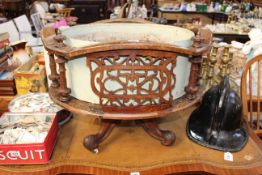 Victorian walnut oval fretwork panelled planter on four scrolled legs.