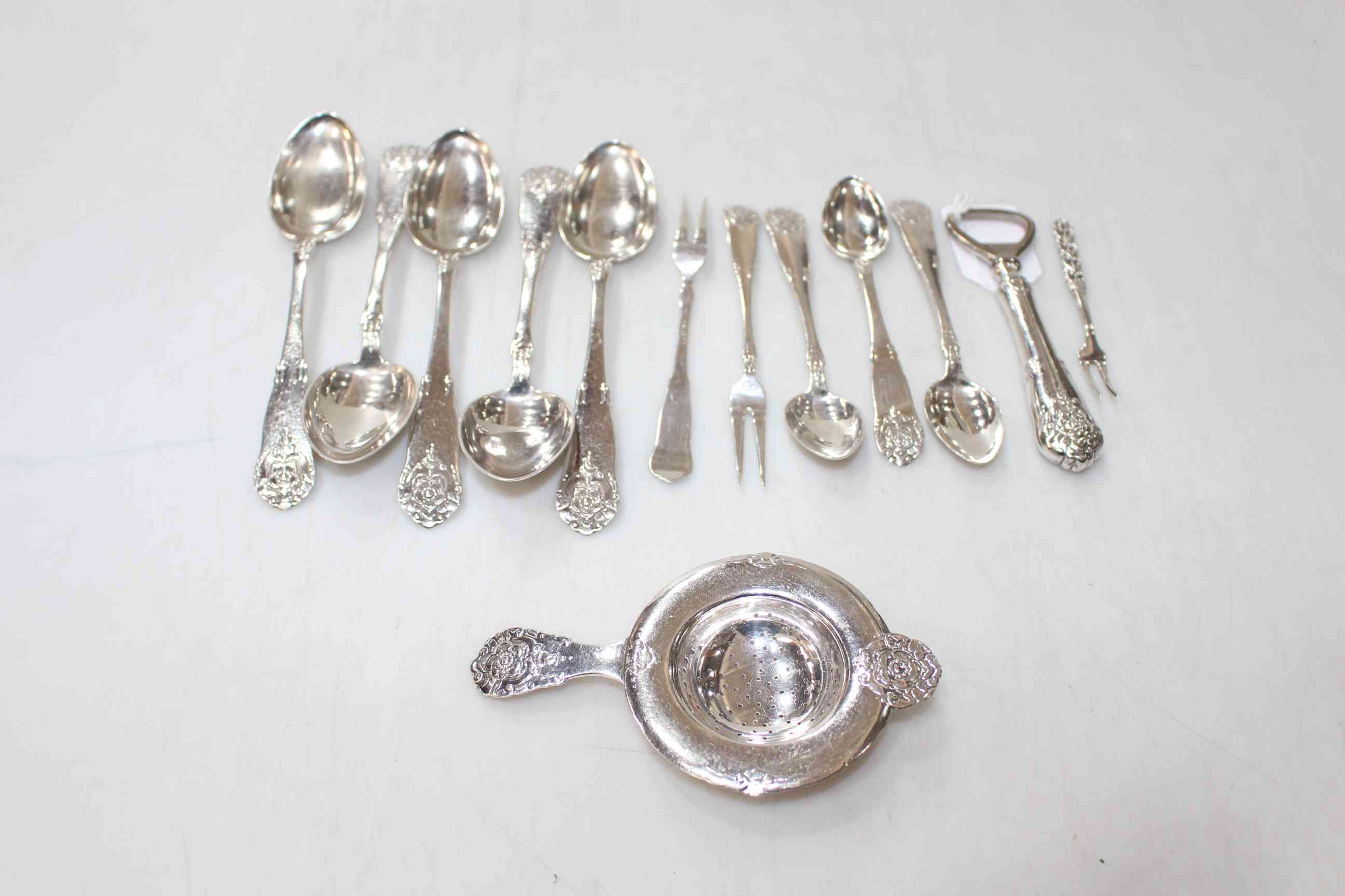 Odin Damaas silver flatware, and strainer, pickle fork and bottle opener, 13 pieces.