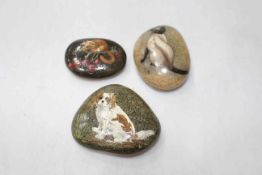 Three stones painted with mouse, spaniel and Siamese cat.