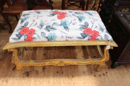 Giltwood stool in floral fabric, 66cm by 106cm by 66cm.