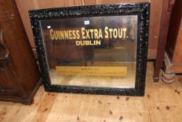 Bevelled wall mirror in painted frame, marked Guinness Extra Stout,