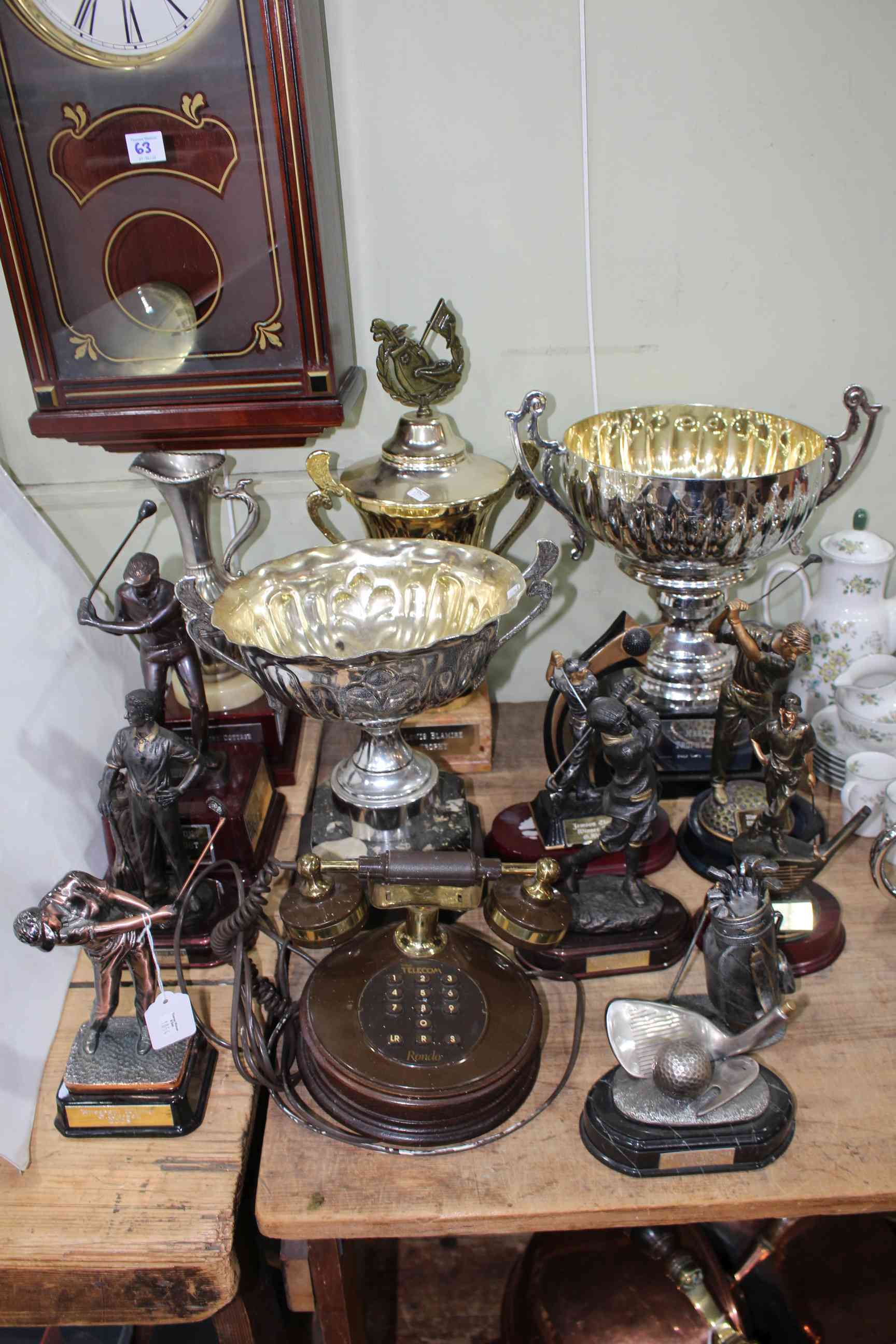 Collection of golf trophies and cups, together with vintage Rondo telephone and wall clock.