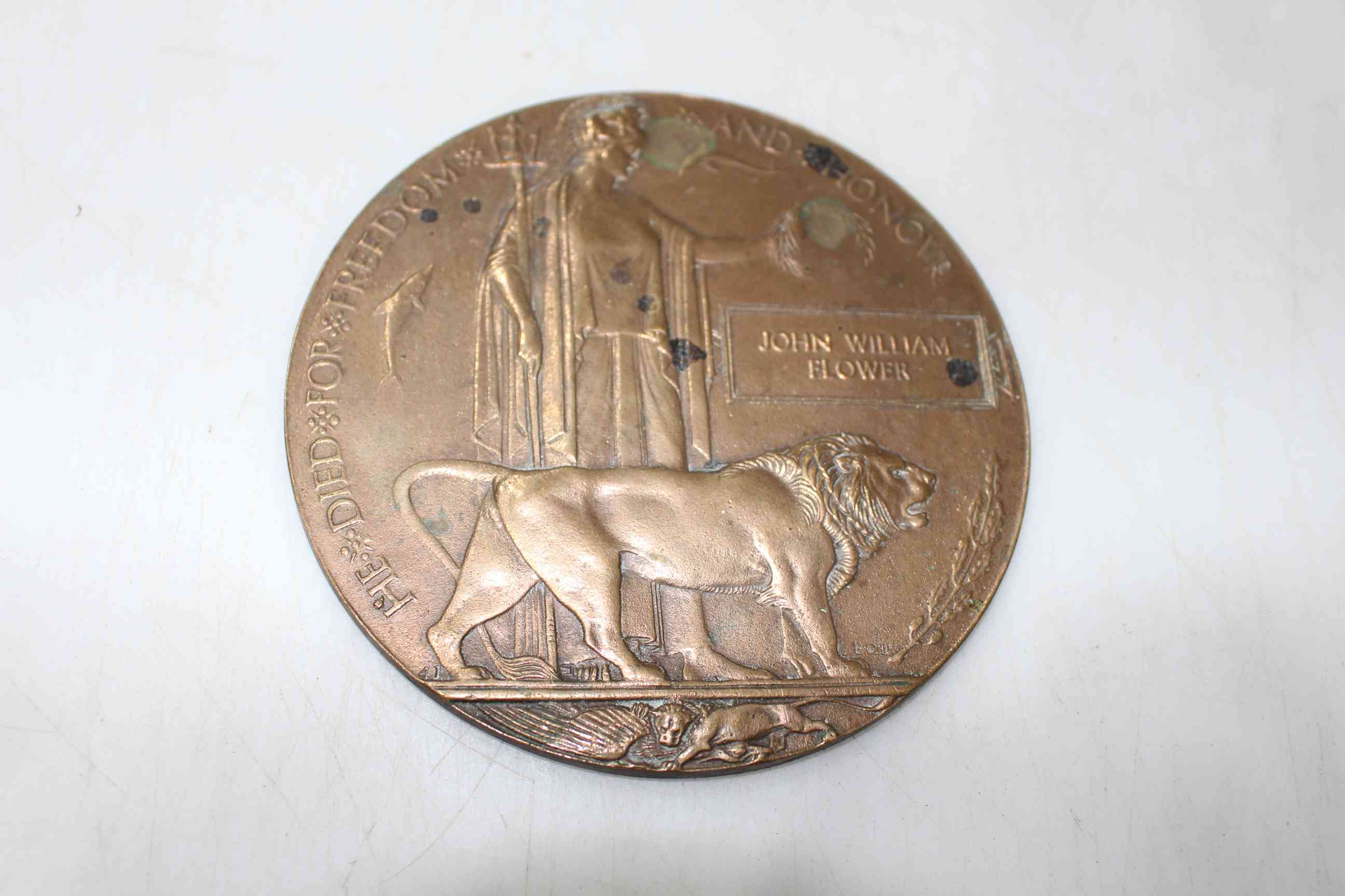 WWI death plaque belonging to 'Gunner John William Flower' of the Royal Field artillery,