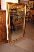 Gilt framed rectangular bevelled wall mirror, 136cm by 75cm overall.