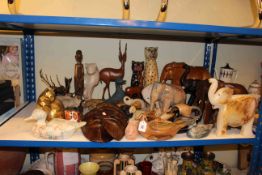 Collection of wooden elephants, ducks, tribal masks and sculpture, brass cat, etc.