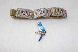 An enamelled parrot brooch and a mosaic link bracelet.