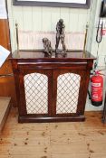 Victorian rosewood chiffonier having brass rail and fabric back and two grille doors,