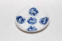 Chinese blue and white saucer dish with five dragon roundels, 13.5cm diameter.