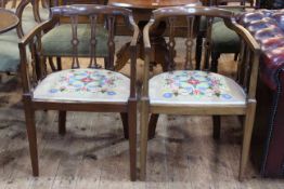 Pair Edwardian mahogany occasional elbow chairs with needlework seats.