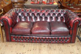 Ox blood buttoned leather three seater Chesterfield settee.