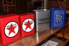 Aston Martin and Rolls Royce advert petrol cans and two Texaco advert tins.