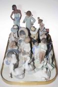 Fourteen Nao figures and one Lladro piece of Girl on Telephone.