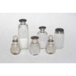 Six silver topped/collared bottles.