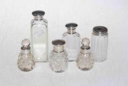 Six silver topped/collared bottles.