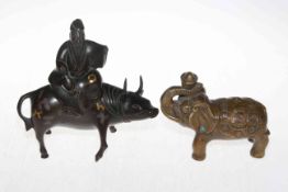 Small bronze elephant, 14cm length, and bronze figure and cow incense burner (2).