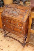 1920's Jacobean style oak two drawer bureau, 99cm by 75cm by 43cm.