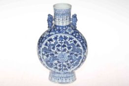 Antique Chinese blue and white moon flask vase with dragon, foliate and blossom decoration, 25cm.