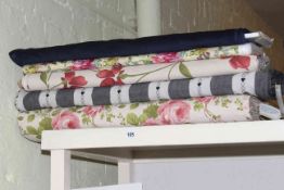 Thirteen rolls of fabric with various design, various lengths and widths.