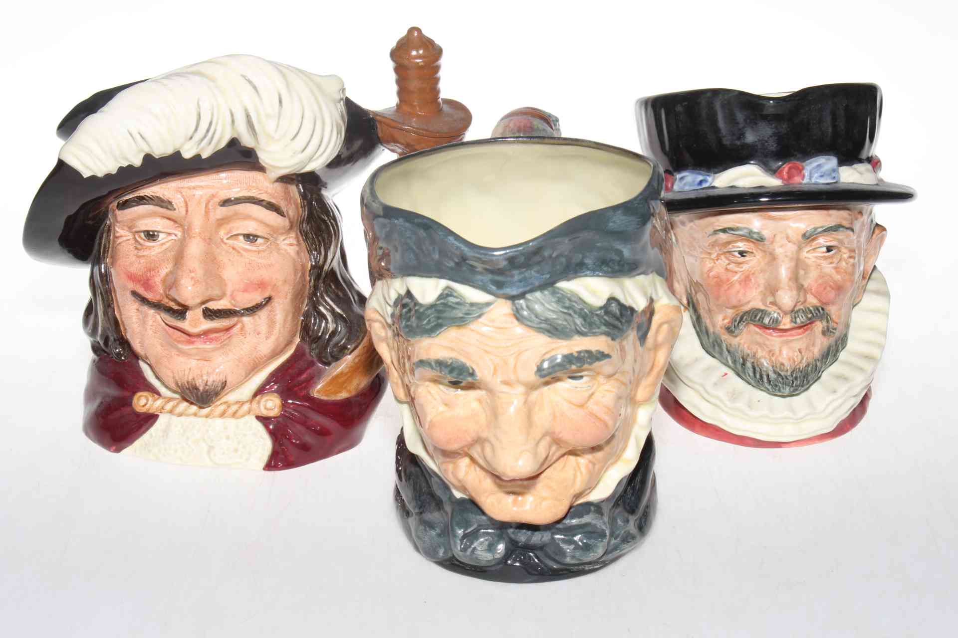 Three Royal Doulton character jugs, Beefeater, Porthos, and Granny with Tooth.