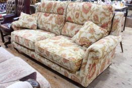 Parker Knoll two seater settee in classical floral fabric.