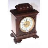 Carved walnut mantel clock with French movement by Maple & Co. Ltd Paris, 36cm.