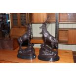 Pair of impressive bronze models of stags standing on rocky outcrops upon marble bases, 74cm high.