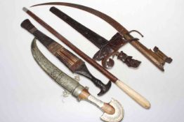 Collection of four Eastern daggers, and leather bound baton (5).