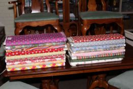 Seventeen rolls of patterned fabric of varying lengths.