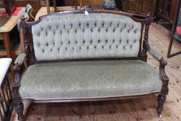 Victorian carved mahogany framed parlour settee in green buttoned fabric.