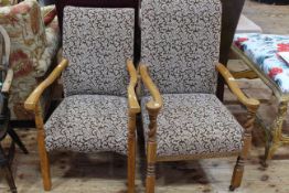 Two early 20th Century oak framed armchairs in matching fabric.