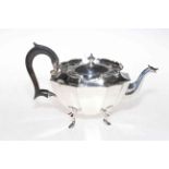 Edwardian ornate silver teapot of concave panel oval form, Birmingham 1902, 14cm high.