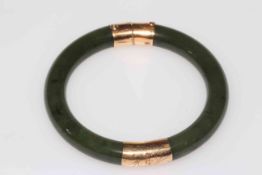 14k gold mounted green jade bangle.