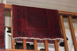 Persian design red and black rug 1.35 by 0.85.