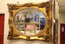 Laura Ashley ornate gilt framed oval bevelled wall mirror, 85cm by 105cm.